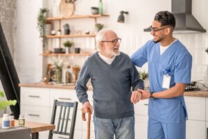 Medical,Worker,Helping,His,Patient,To,Move,Around,The,Apartment