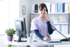 Young,Practitioner,Doctor,Working,At,The,Clinic,Reception,Desk,,She