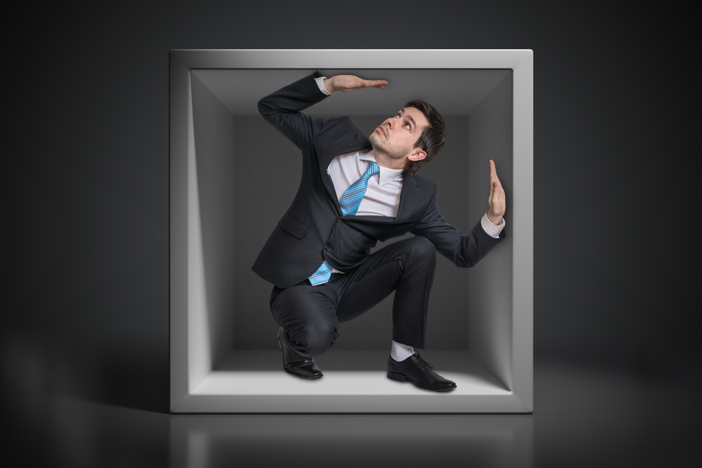 Young,Businessman,Trapped,Inside,Uncomfortable,Small,Box.